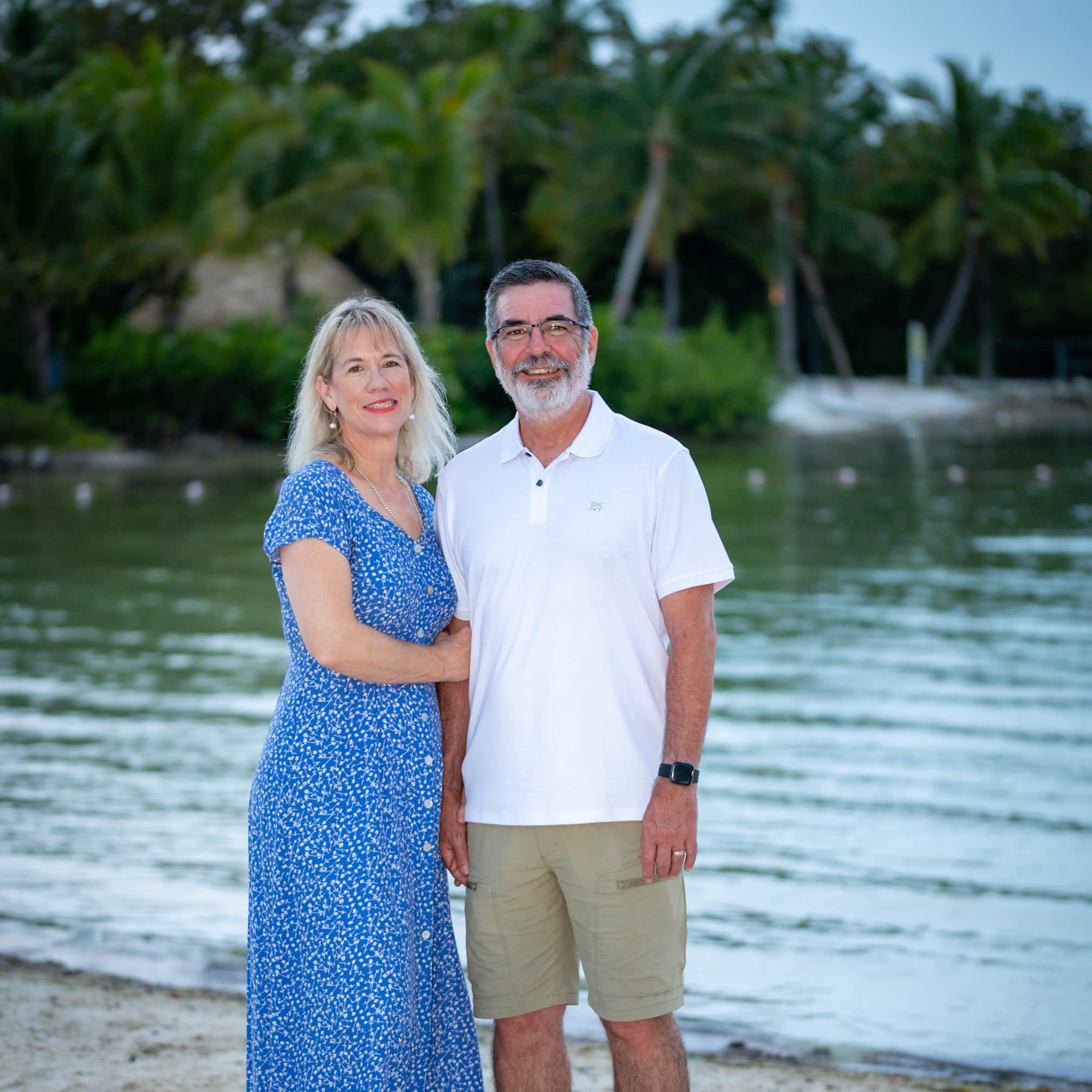 Philip &amp; Laura standing on a beach.