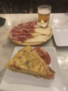 Valencia Old Town: History You Can Walk Through 3 A plate of Spanish tortilla with jamón and cheese served as part of a tapas tour in Valencia.