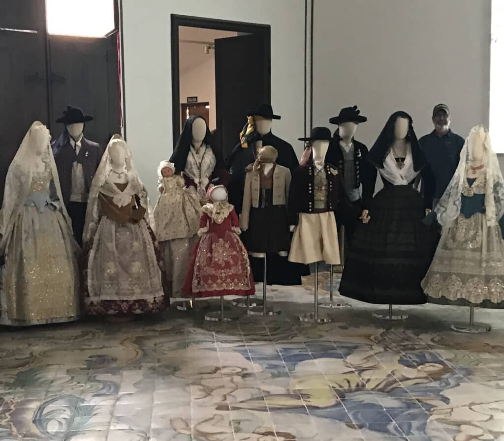 Traditional Valencian silk dresses and ceremonial outfits are on display inside the Silk Museum, one of the cultural things to do in Valencia.